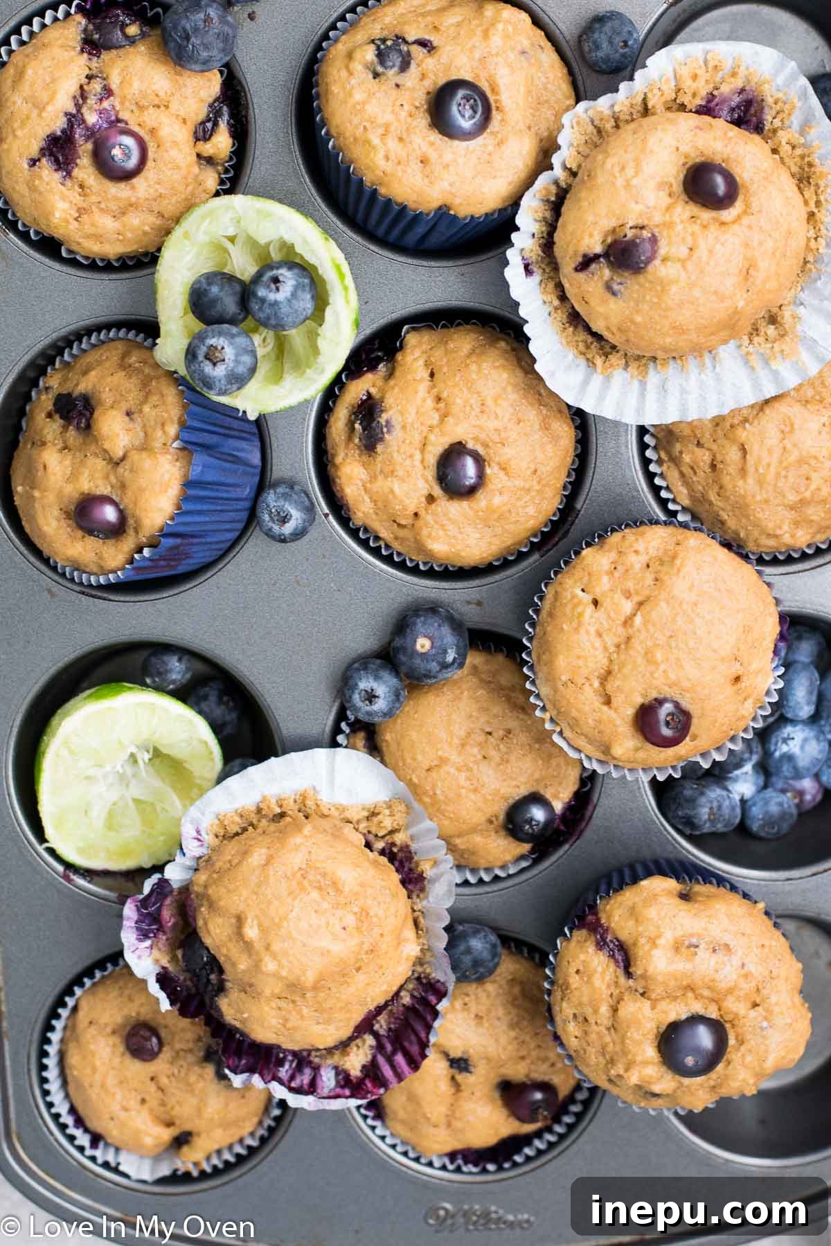 Zesty Blueberry Lime Greek Yogurt Muffins 10 A cutting board with baked Blueberry Lime Muffins