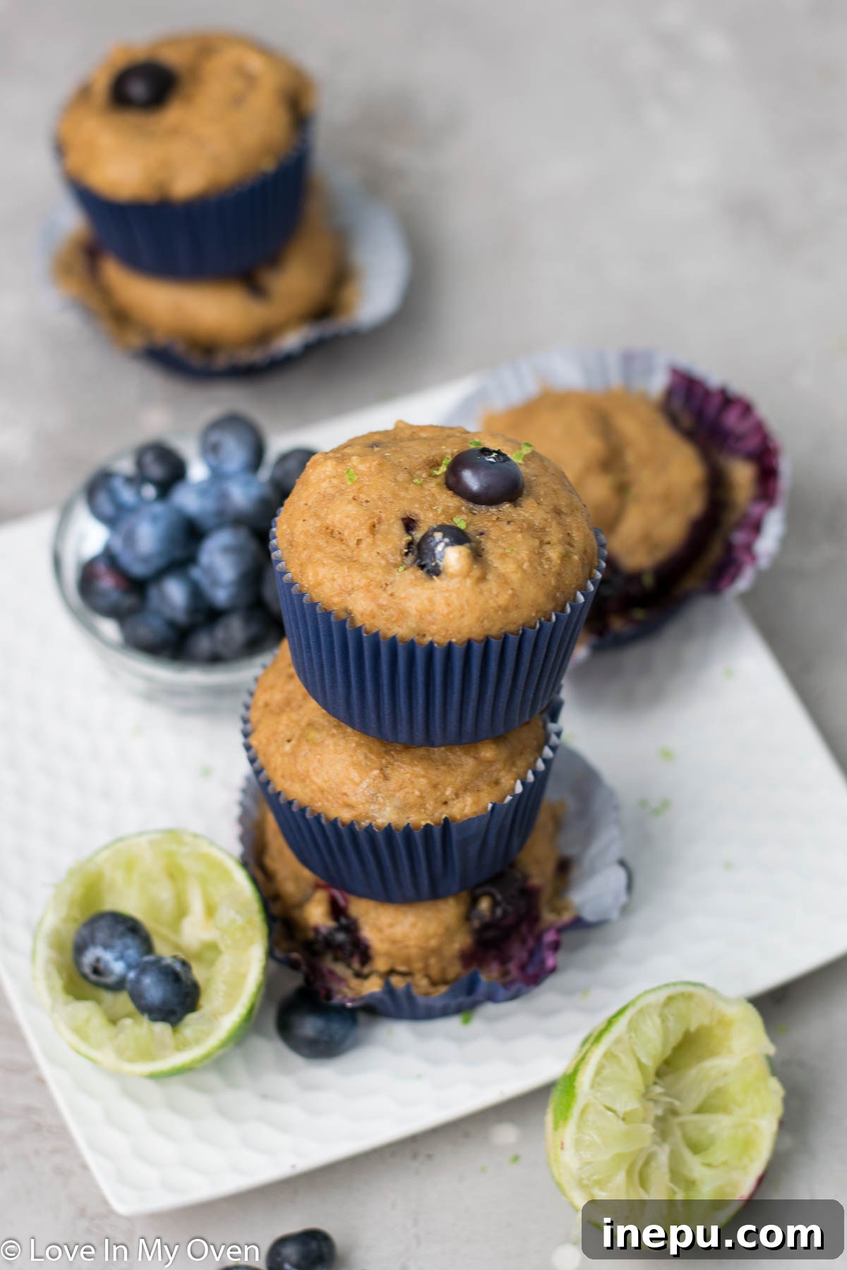 Zesty Blueberry Lime Greek Yogurt Muffins 3 Blueberry Lime Muffins on a cooling rack