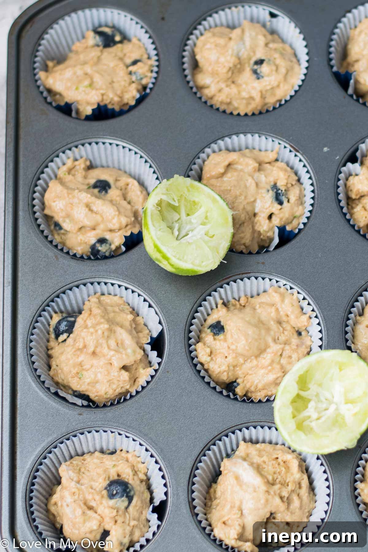 Zesty Blueberry Lime Greek Yogurt Muffins 6 Muffins baking in a pan