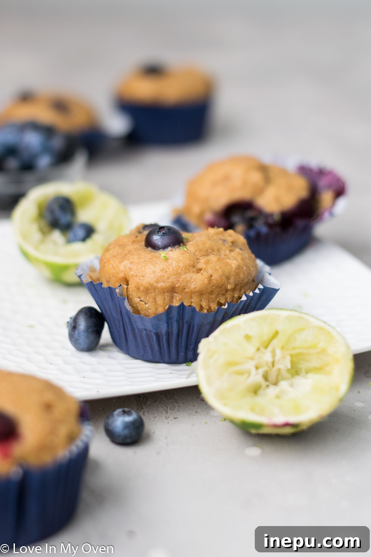 Zesty Blueberry Lime Greek Yogurt Muffins 8 A plate of freshly baked Blueberry Lime Muffins