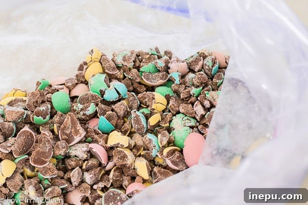 Crushing Cadbury Mini Eggs with a rolling pin for the cookie recipe