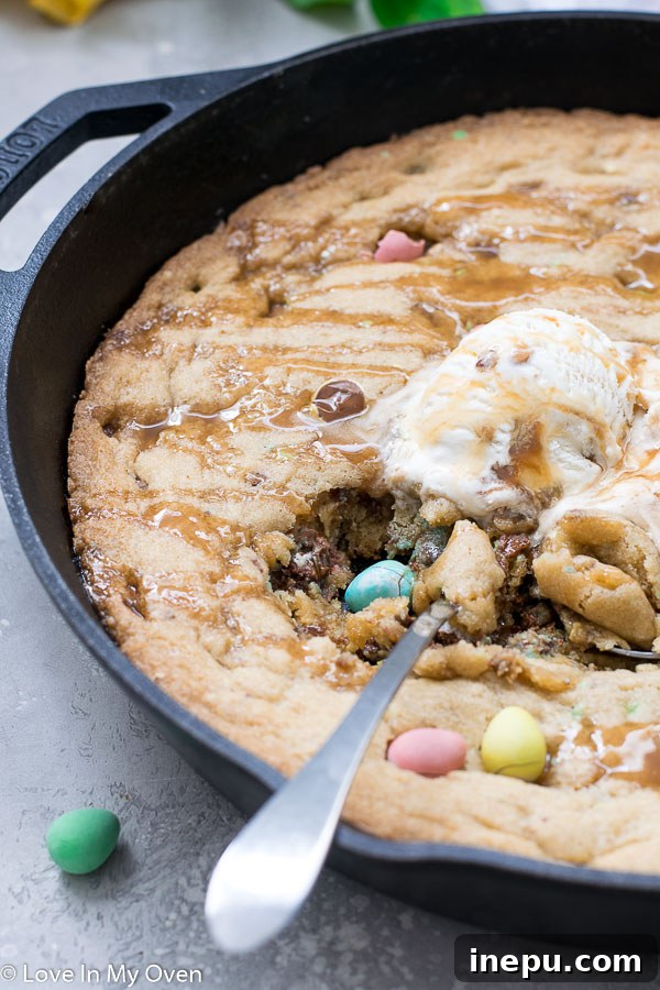 Sharing a slice of mini egg skillet cookie directly from the pan