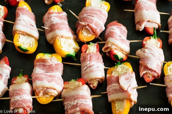 Golden Pepper Poppers 5 Preparation step: Bacon wrapped around cream cheese stuffed mini bell peppers