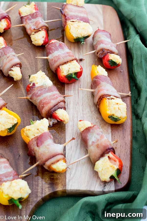 Golden Pepper Poppers 6 Close-up of baked bacon-wrapped mini bell pepper poppers on a serving plate