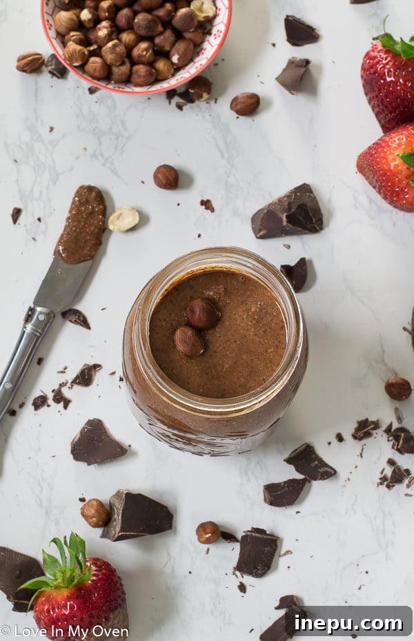 A top-down view of a jar of homemade Notella, showcasing its rich, dark chocolate color and smooth texture.
