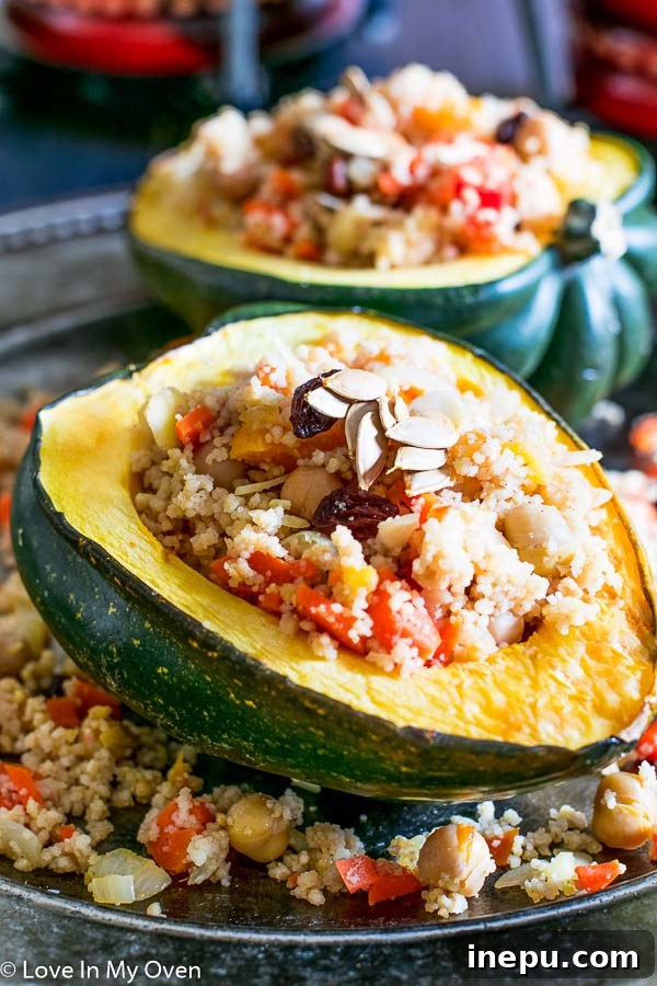 Delicious Moroccan Couscous Stuffed Acorn Squash on a plate, garnished with roasted seeds