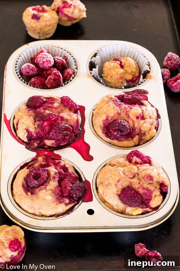 Mini Banana Muffins 5 Baby-friendly banana muffins with raspberries, baked to perfection.