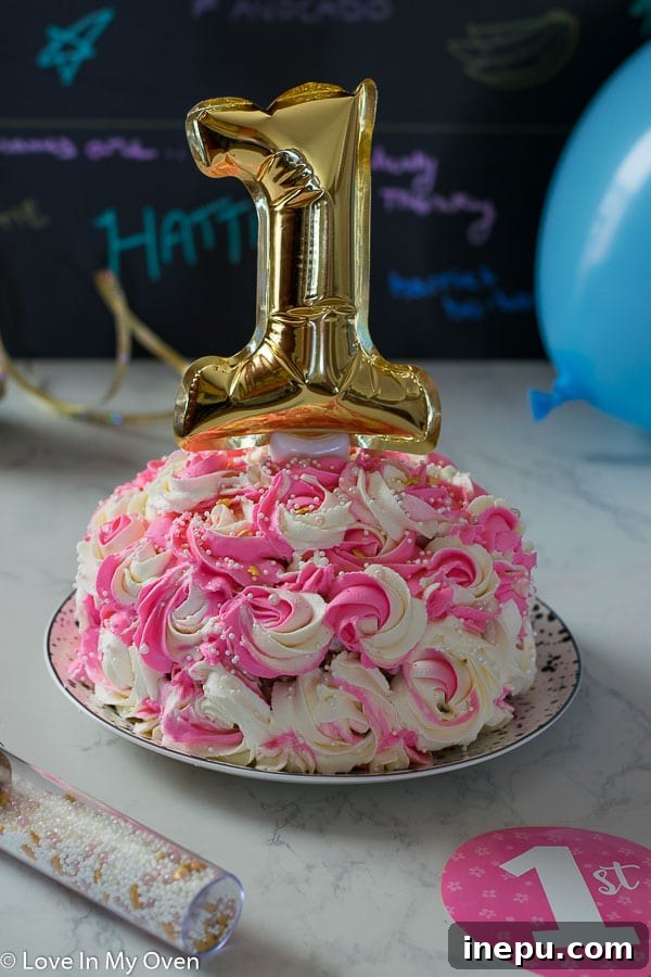 Healthy smash cake with pink rosette frosting for a baby girl's first birthday.