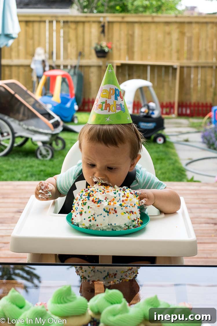 Baby Walter enjoying his first healthy smash cake messy play.