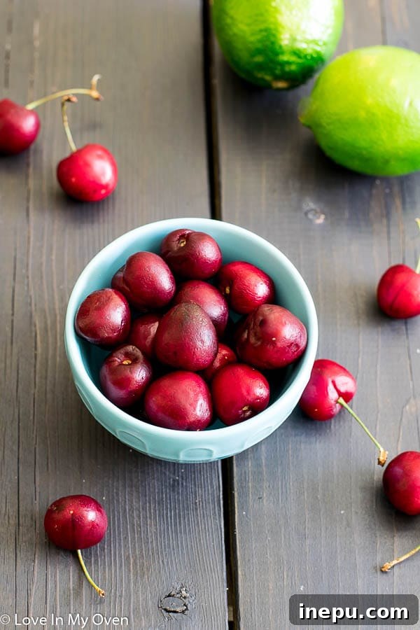Crimson Cherry Delight 4 Ingredients for a Cherry Whiskey Sour including fresh cherries, lime, and whiskey