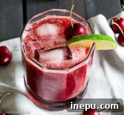 Cherry Whiskey Sour cocktail with fresh cherries