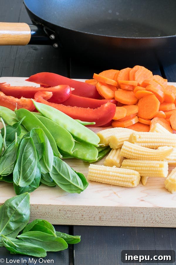 Freshly chopped vegetables and sweet basil, ready for Thai Green Chicken Curry.