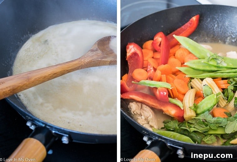 A large wok filled with creamy Thai Green Chicken Curry, simmering on the stovetop.