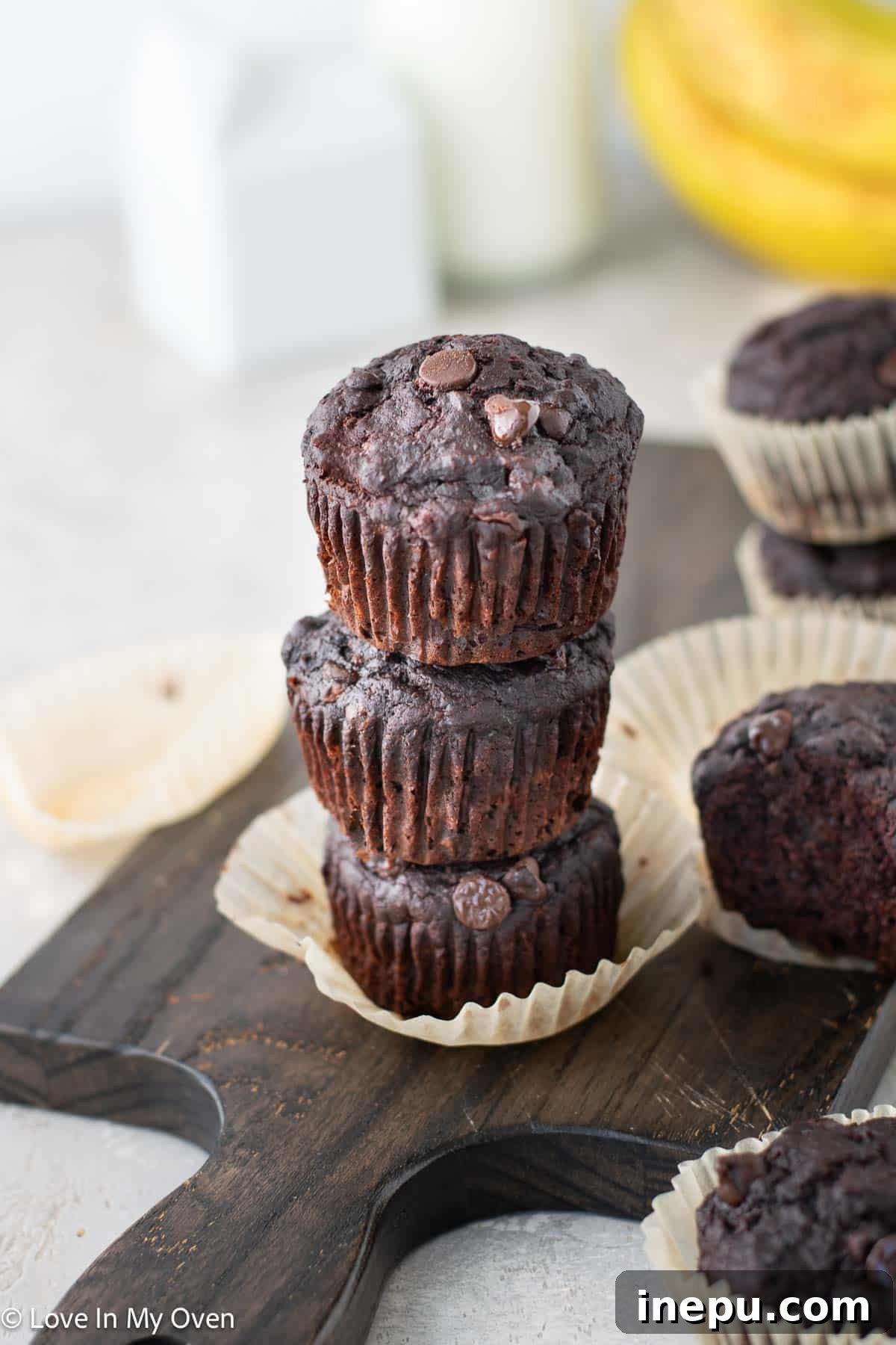 Freshly baked double chocolate banana muffins on a cooling rack