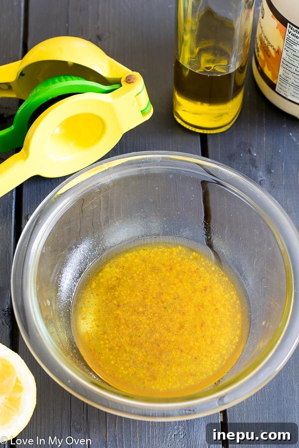 Whisking maple-lemon vinaigrette in a bowl