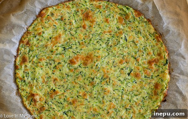 Gluten-Free Zucchini Crust Pizza 5 Partially baked zucchini pizza crust on parchment paper