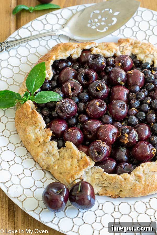 saskatoon cherry galette - a rustic pie with berries and a golden crust