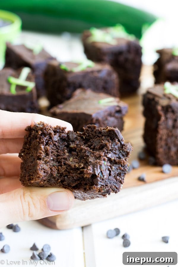 Guilt-Free Double Chocolate Zucchini Brownies 4 Freshly baked healthier zucchini brownies ready to be frosted