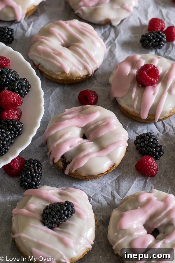 Mixed Berry Vanilla Donuts - Soft, fluffy, and naturally sweetened baked donuts with fresh berries and vanilla glaze.