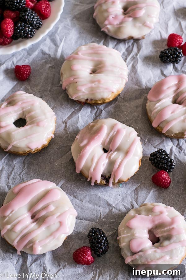 Mixed Berry Vanilla Donuts - Close-up of glazed donuts with fresh berries.