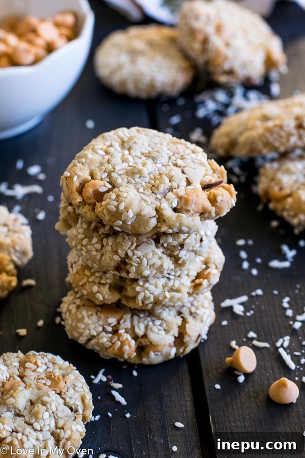 Stack of finished Butterscotch Mountain Cookies with sesame seeds.