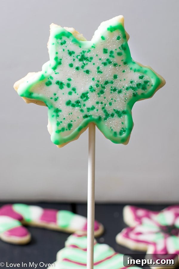 Holiday Cookie Pops 6 A collection of decorated vanilla bean Christmas cookie pops, showcasing various holiday designs.