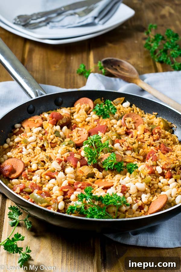 Serving Zesty Sausage and White Bean Skillet with a spoon