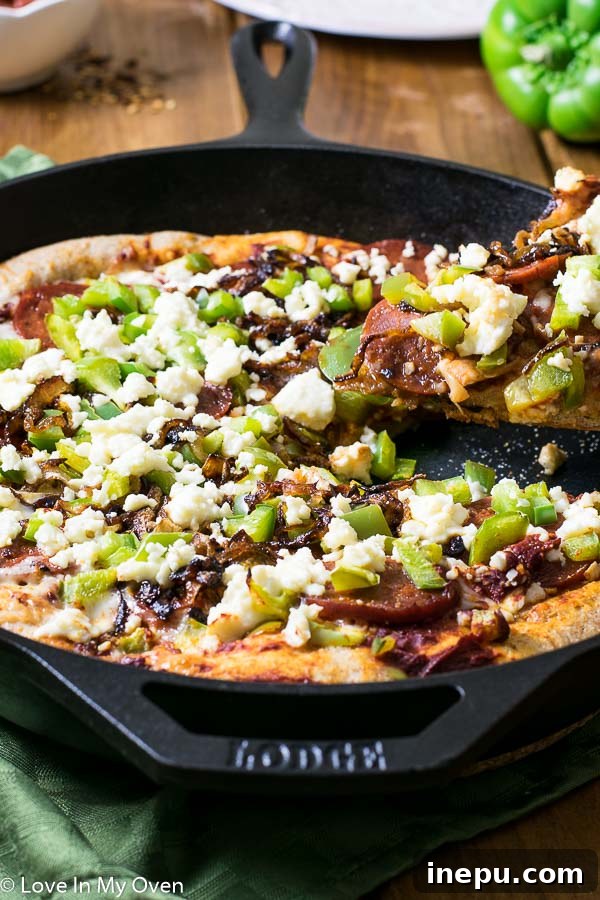 Sweet & Savory Chorizo Onion Pizza 3 A close-up of a Cast Iron Chorizo Pizza, showcasing the bubbly cheese, rich chorizo, and tender caramelized onions.