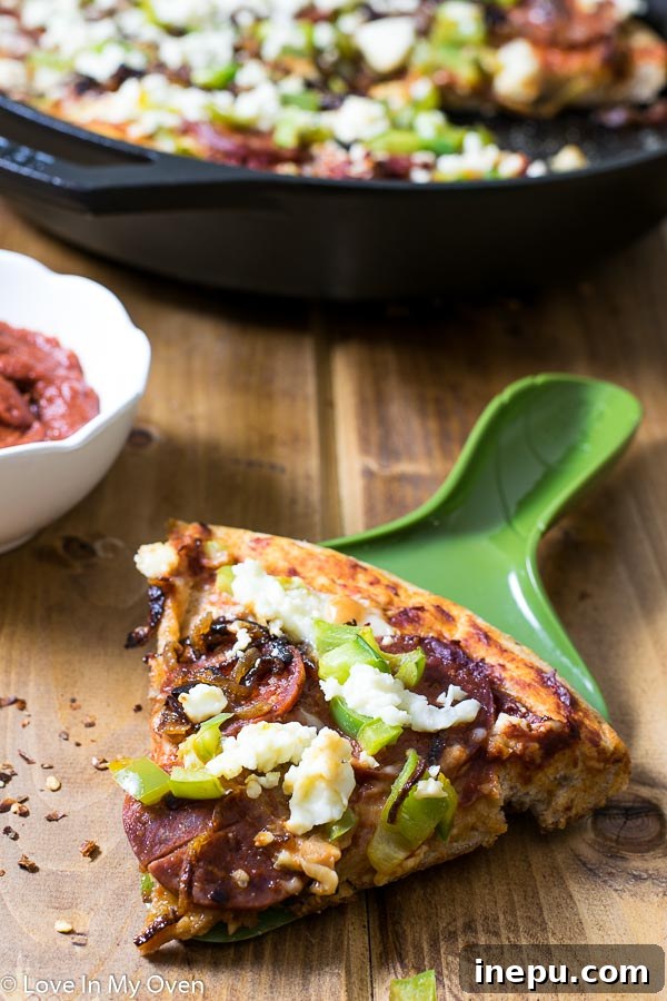 Sweet & Savory Chorizo Onion Pizza 7 Three slices of Chorizo and Caramelized Onion Skillet Pizza on a wooden cutting board, with the rest of the pizza in the background.