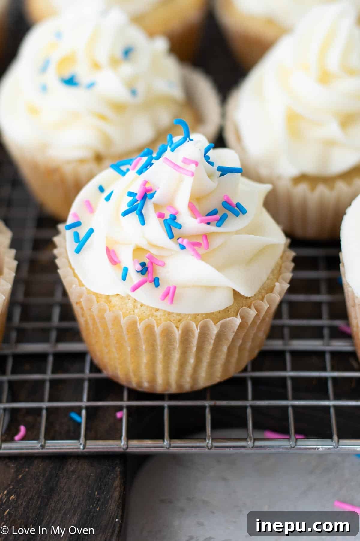 Sweet Gender Surprise 16 Gender reveal cupcakes ready to be served, a perfect centerpiece for a baby celebration.