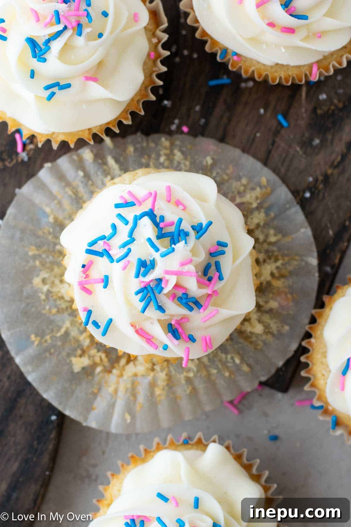 Sweet Gender Surprise 17 A gender reveal cupcake cut in half, revealing a vibrant pink frosting inside, signifying a baby girl.