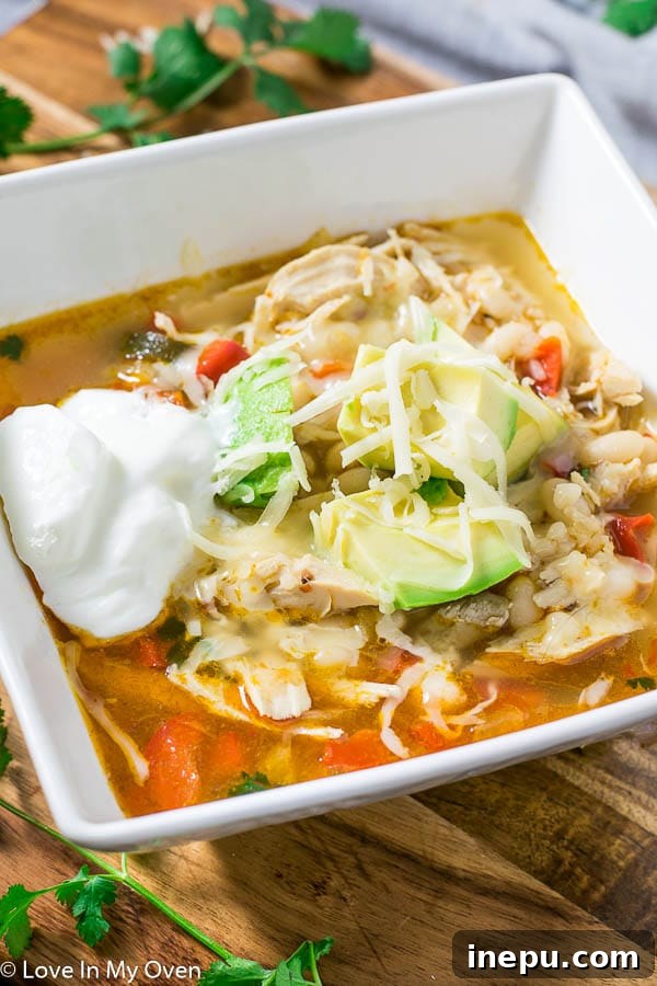 Easy Leftover White Chicken Chili with avocado, cheese, sour cream