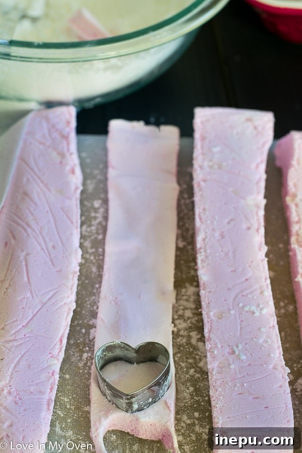 Artisan Chocolate Strawberry Marshmallows 5 Cutting homemade marshmallows with a pizza cutter