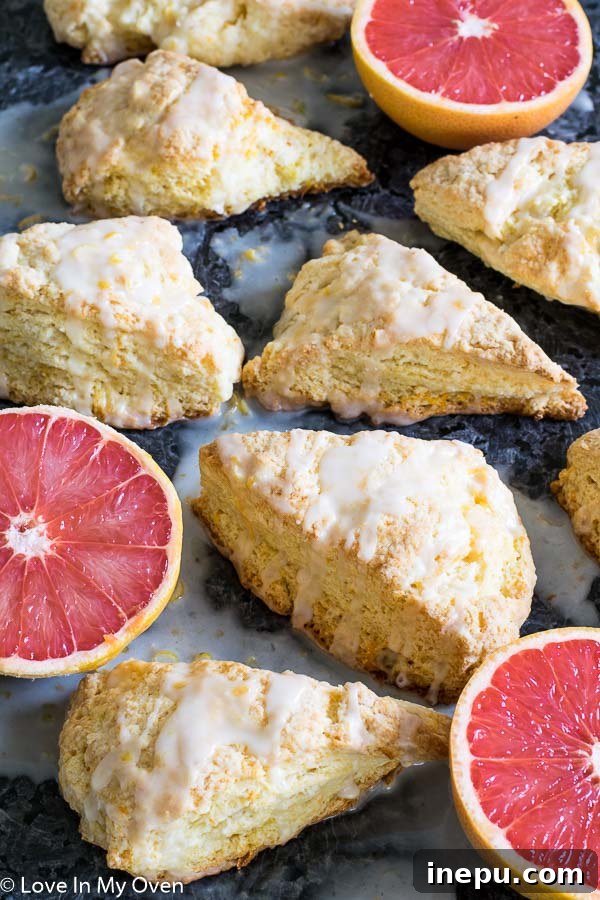 Zesty Grapefruit Scones 6 Perfectly baked Glazed Grapefruit Scones on a cooling rack