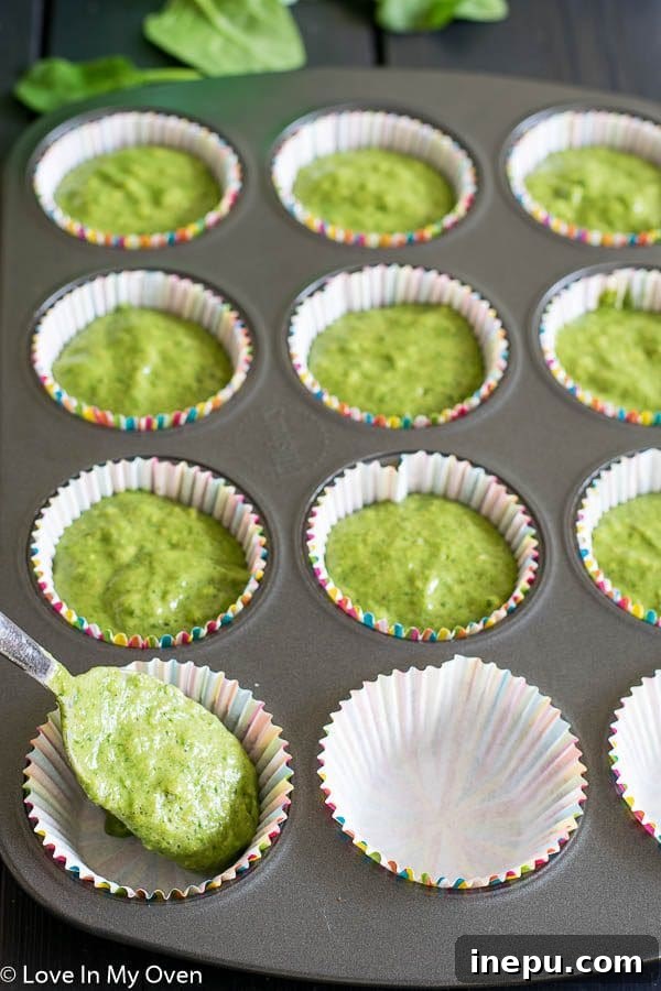 Emerald Monster Muffins 5 A plate of two green monster muffins, perfect for a healthy snack.