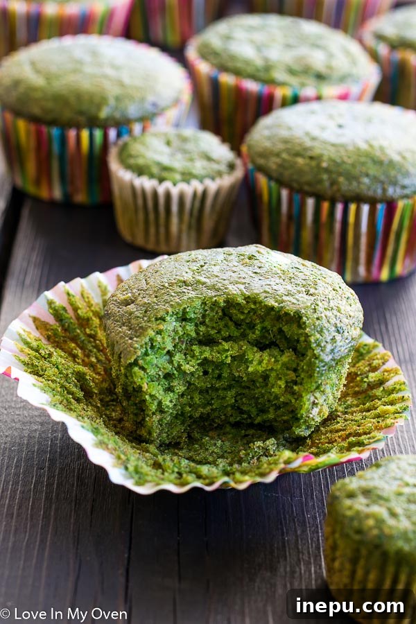Emerald Monster Muffins 8 Individual green monster muffin with a bite taken out, revealing its soft interior.