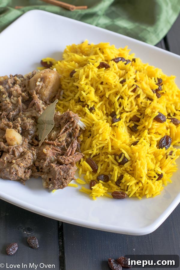 Cape Malay Golden Rice 6 A bowl of South African Yellow Rice with a spoon, highlighting its inviting texture and colors.
