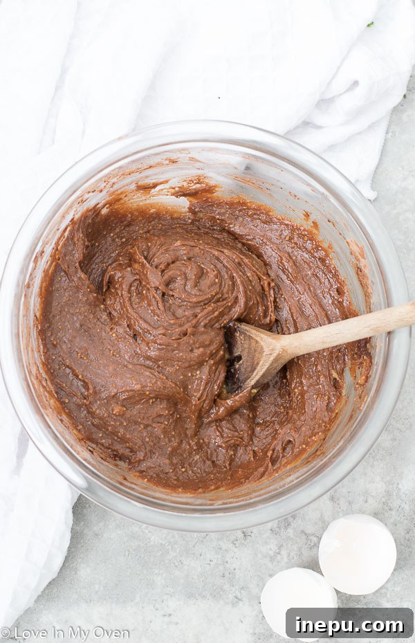 Decadent Gluten Free Brownies 5 Brownie batter spread in a cast iron skillet