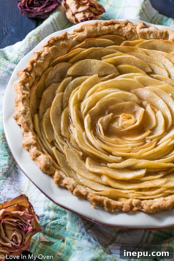 Close-up of a beautiful salted caramel apple rose pie with golden crust