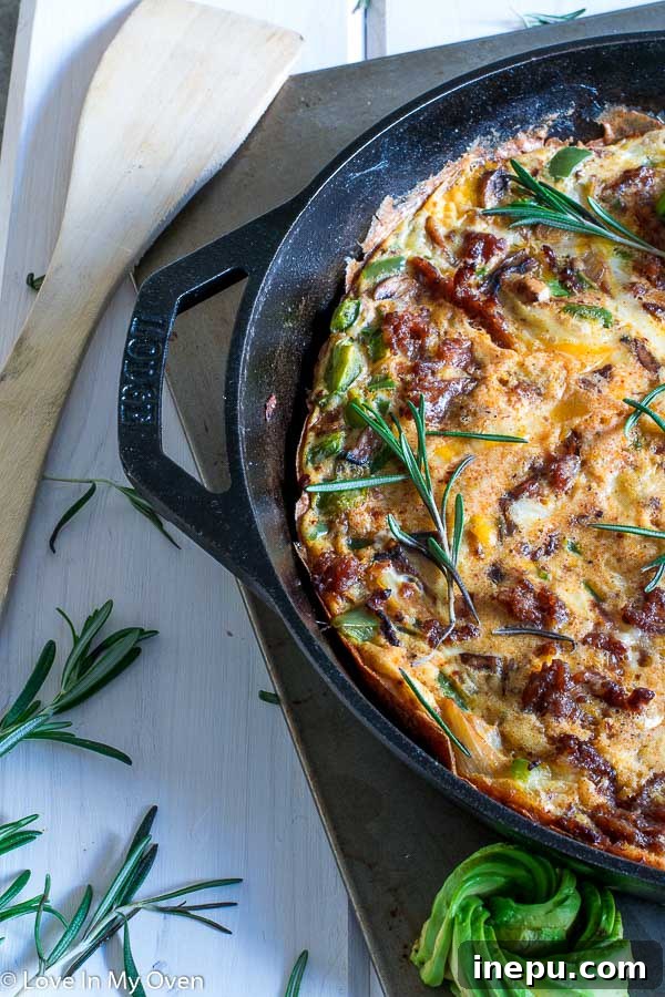 Spicy Keto Chorizo Frittata 4 A slice of Keto Chorizo Frittata, topped with avocado and sour cream