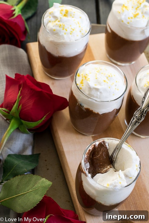 Delicious chocolate chia pudding cups topped with whipped coconut cream, perfect for Valentine's Day