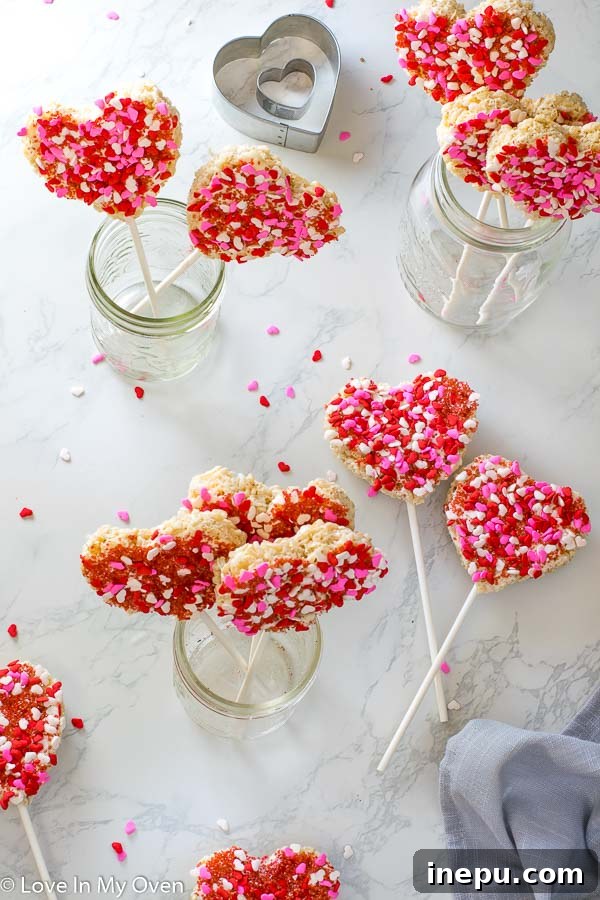 Heart-shaped Rice Krispie treats decorated with sprinkles, a fun Valentine's Day dessert